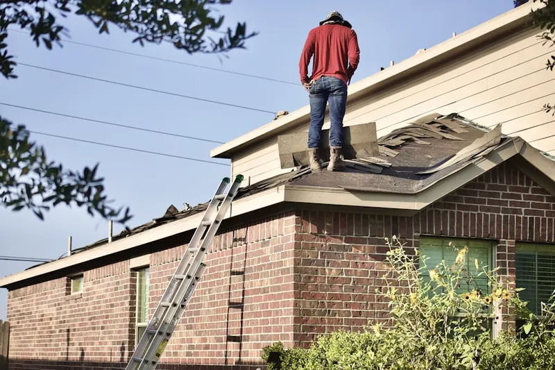Professional roofer working on a residential roof in Woodland Acres
